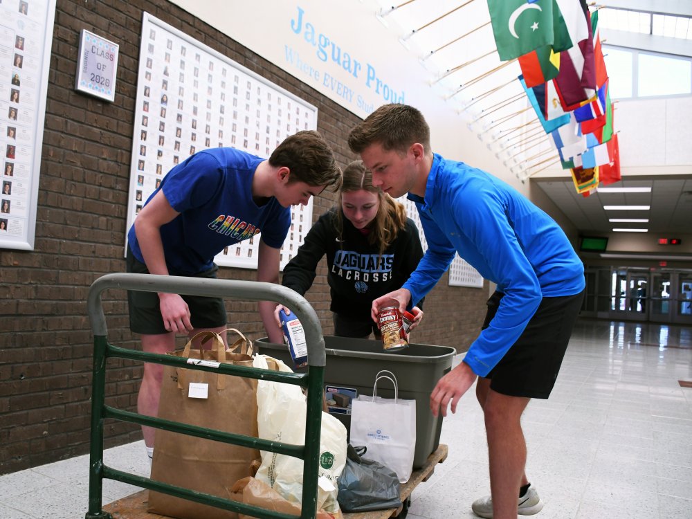 Jefferson students load food donation onto a cart