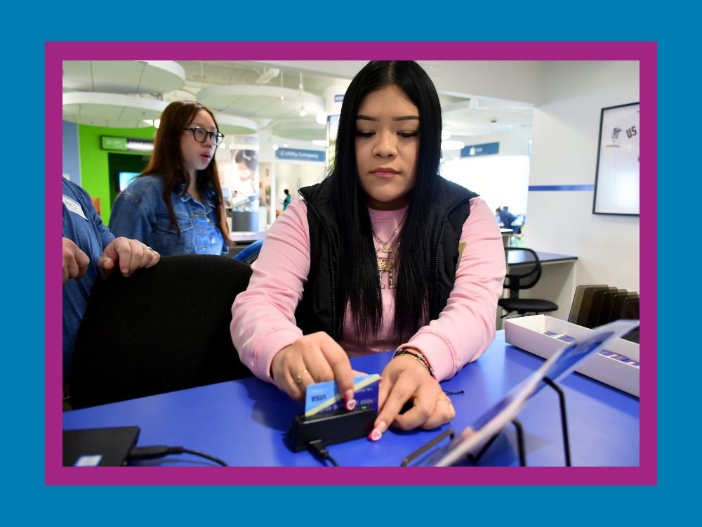 student swiping a mock credit card