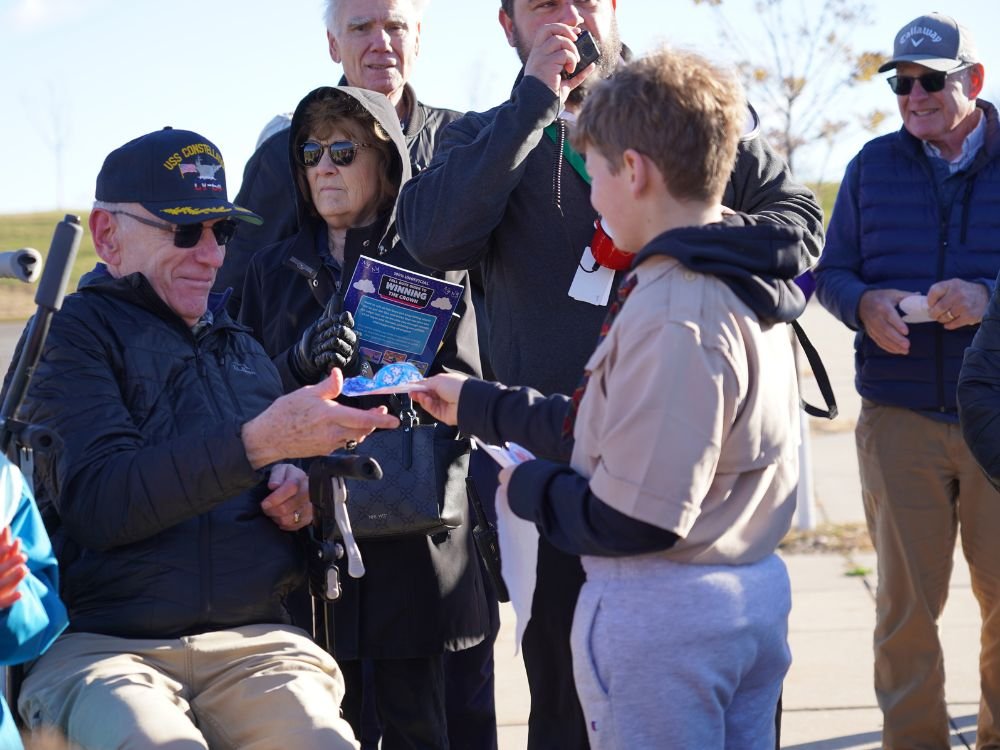 veteran receiving note from a cub scout