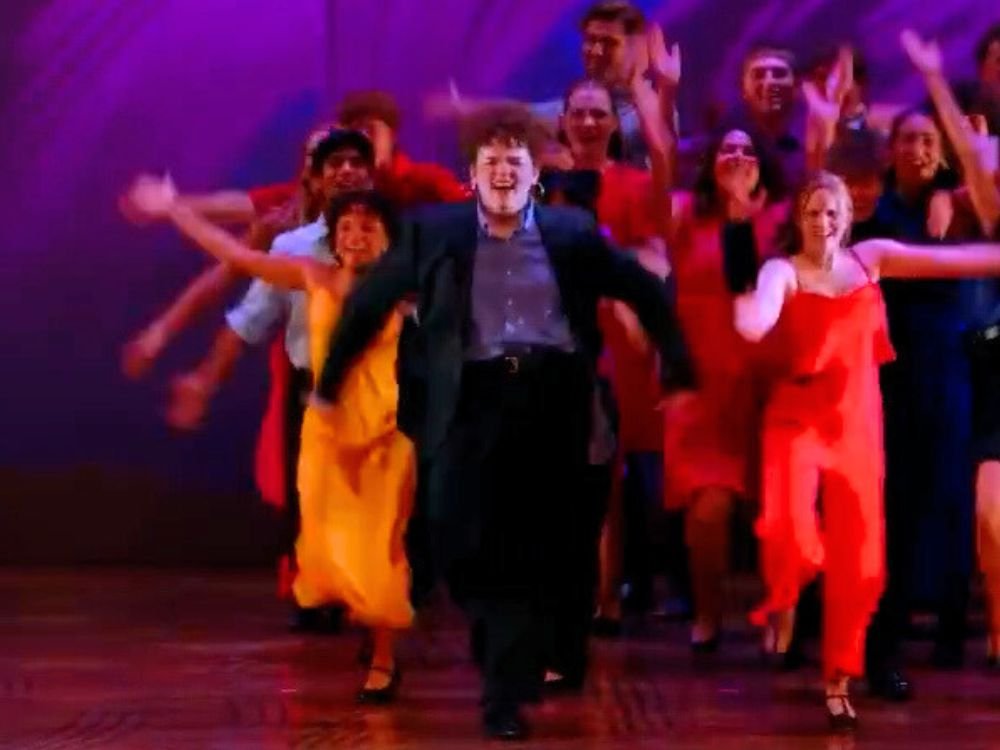 students performing a musical number on stage