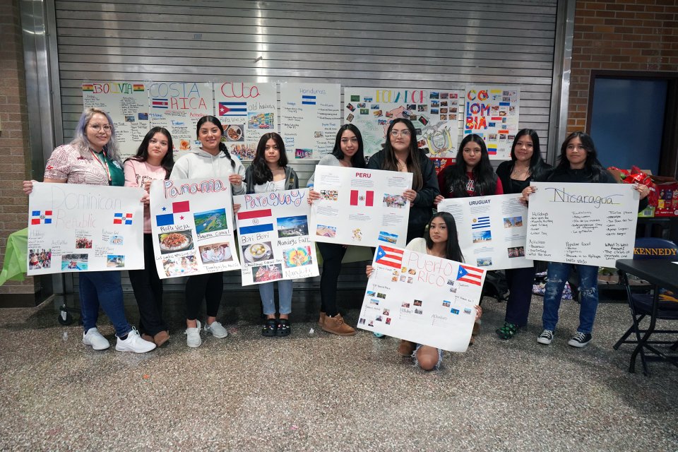 students holding posters about Hispanic countries