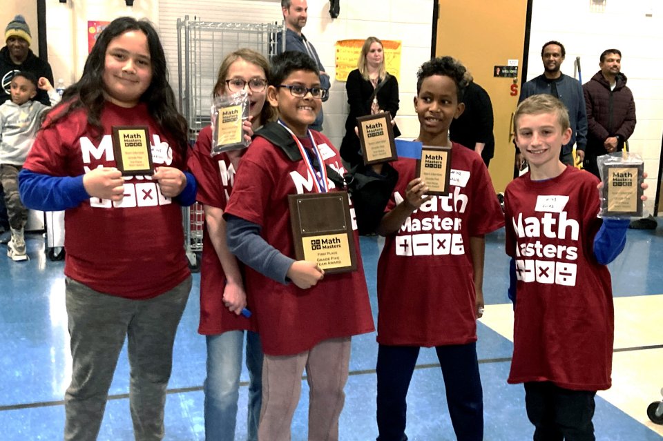 Five students holding their award plaques from Math Masters competition