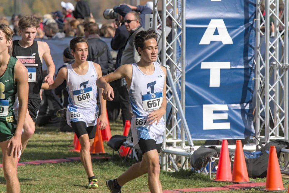 Picture of Alexander and Patrick Altstatt crossing the finish line at the 2024 state cross country meet