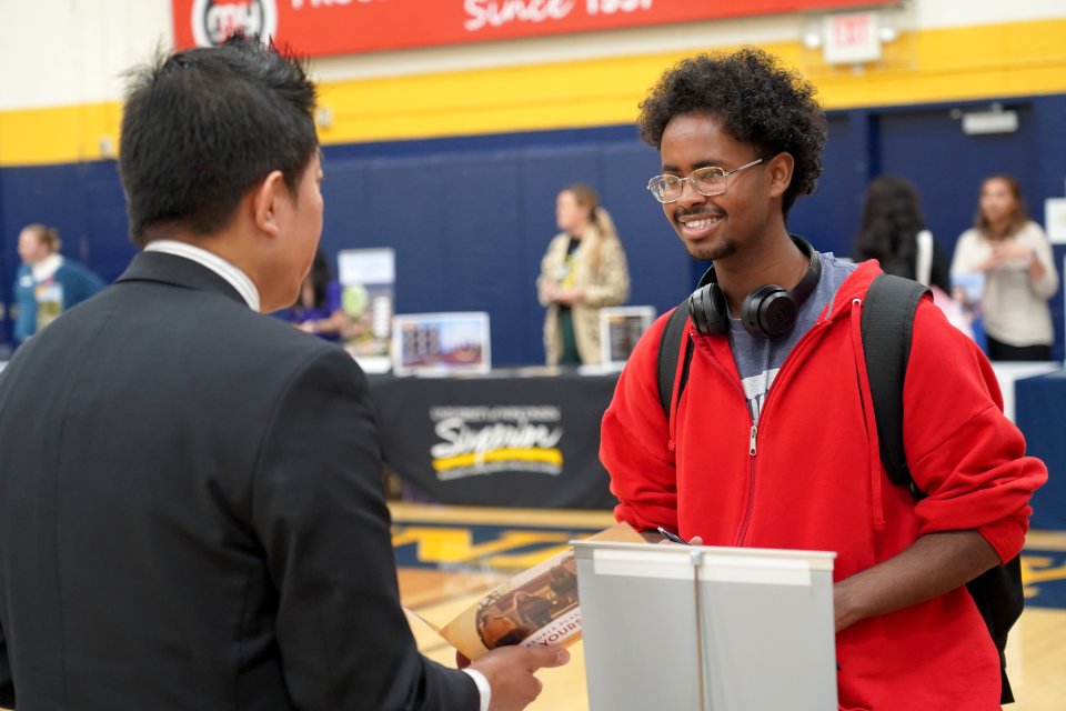student talking to college representative