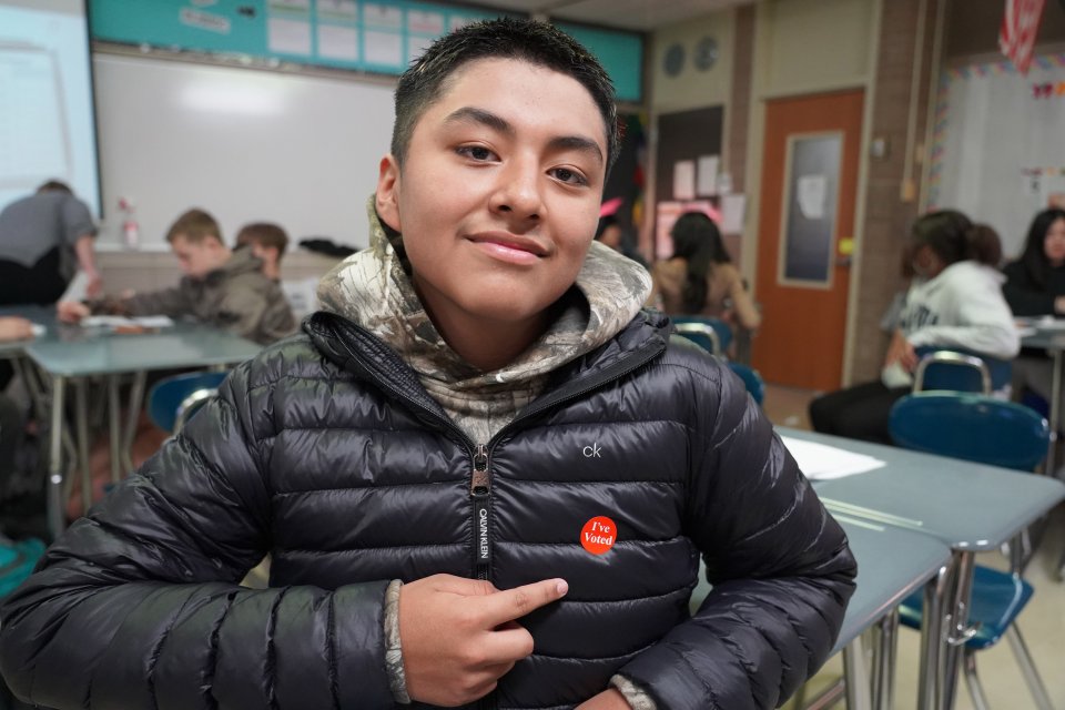 student wearing an "I Voted" sticker