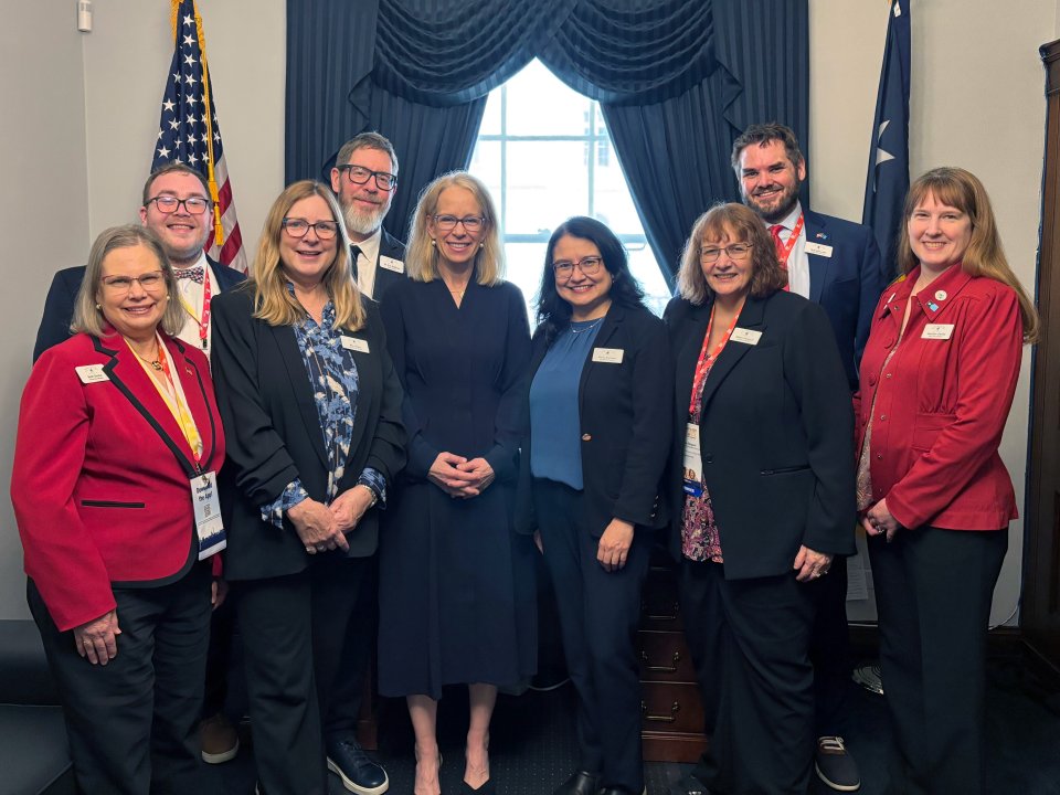 school board members standing with U.S. Representative