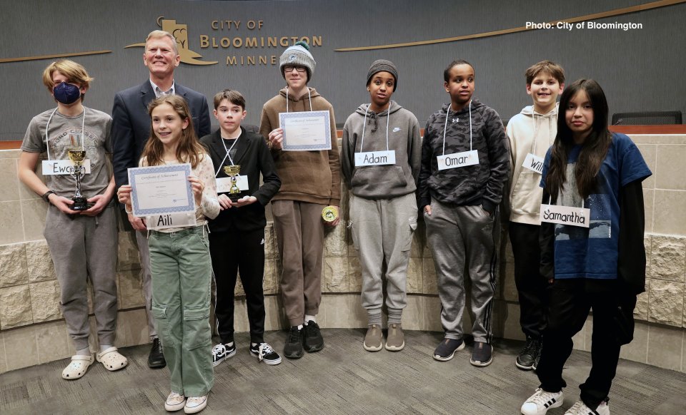 students standing with city mayor