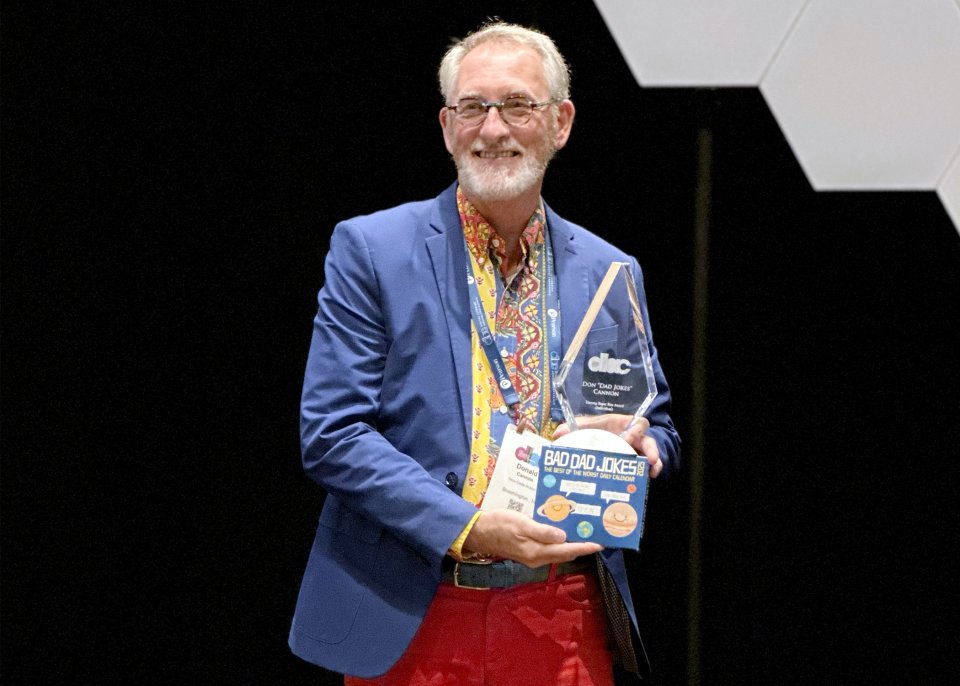 Don Cannon holding award trophy