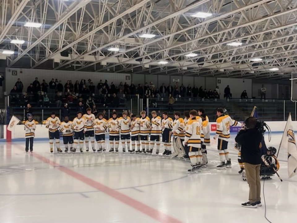 hockey players pour water onto ice