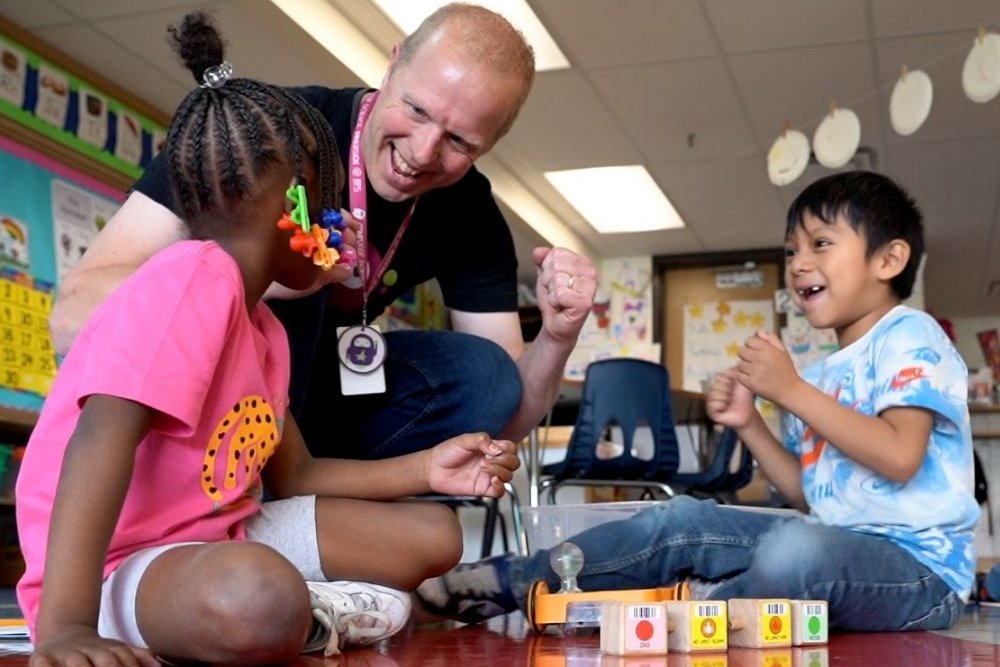 Teacher and two students with blocks