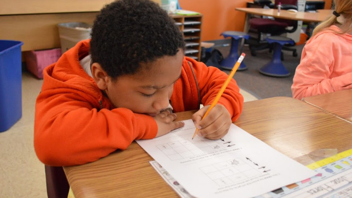 boy writing on paper
