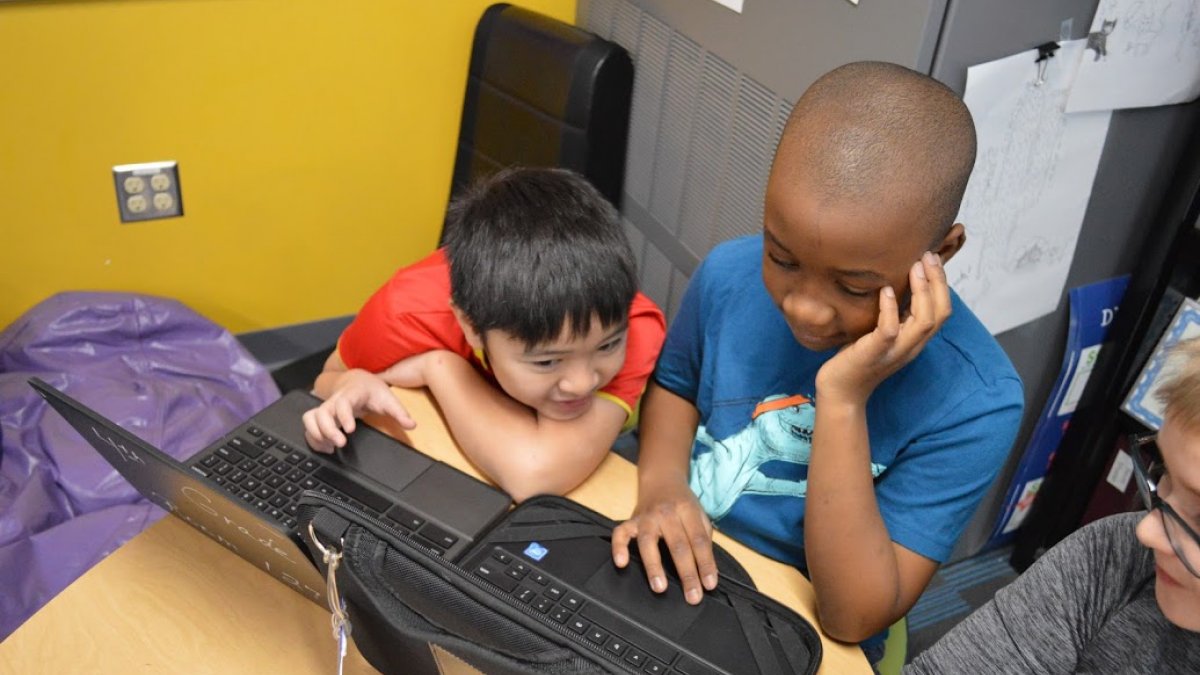 two boys working on Chromebook