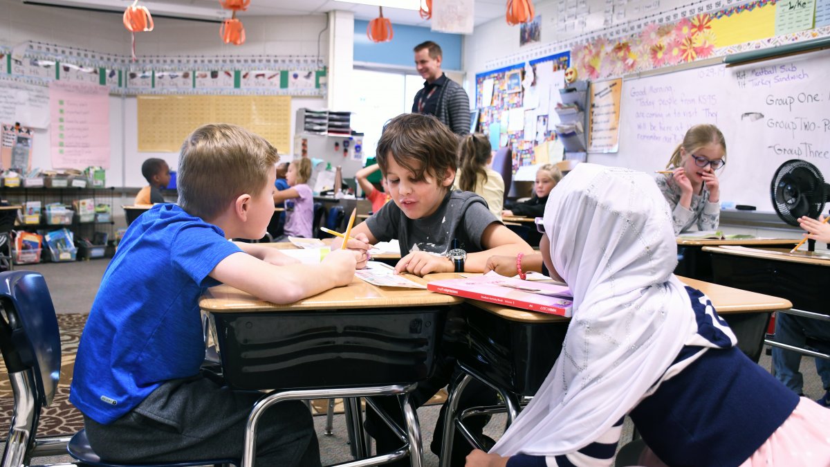 Three students work together on a project