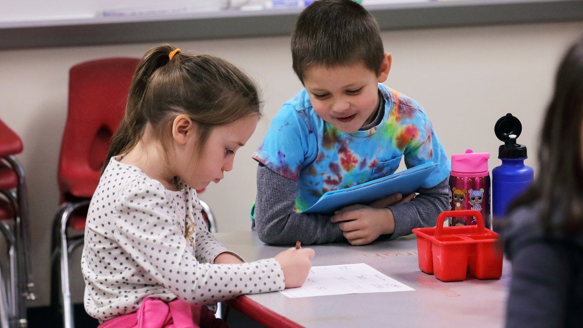Two students work together on a worksheet