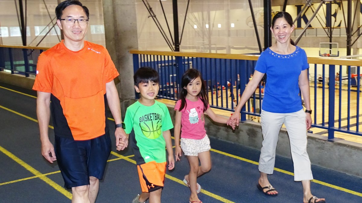 A family of four walks on the walking track