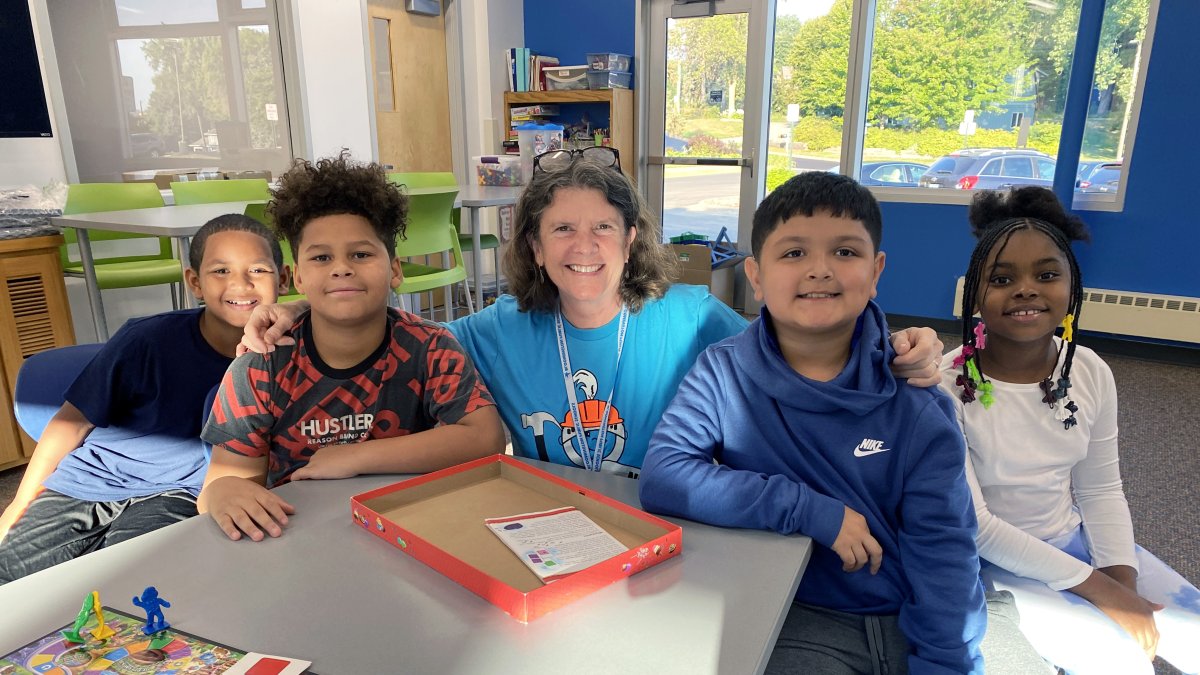 teacher and four students smiling