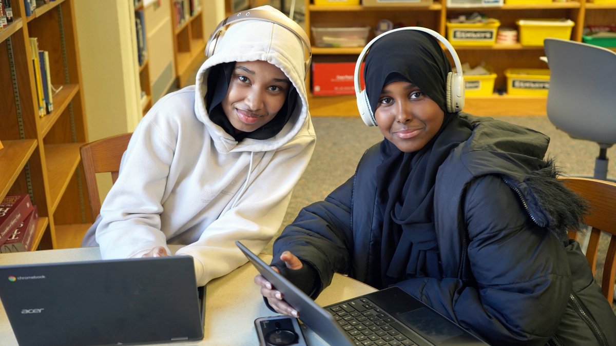 Two students working on laptops