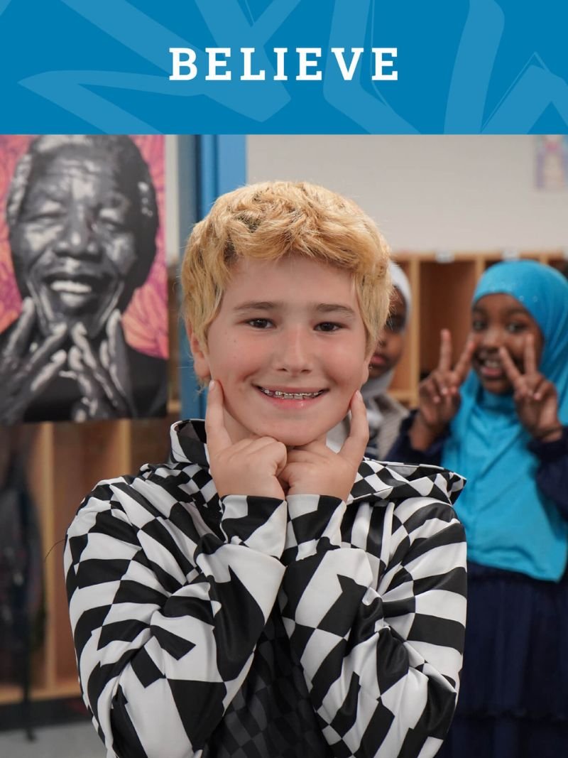 Boy smiling with Believe Text
