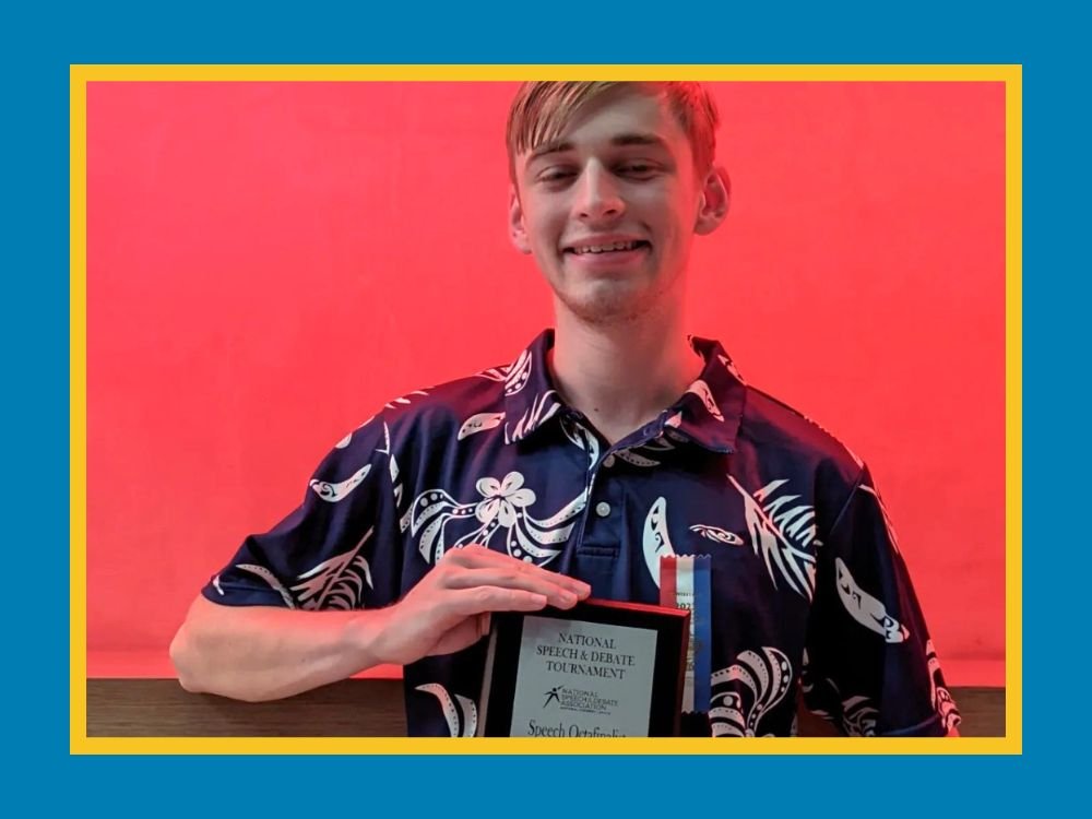 Student holding award plaque