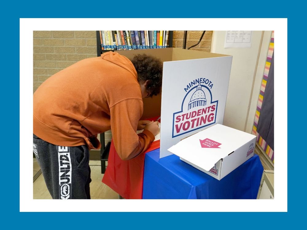 Student filling out ballot in mock election