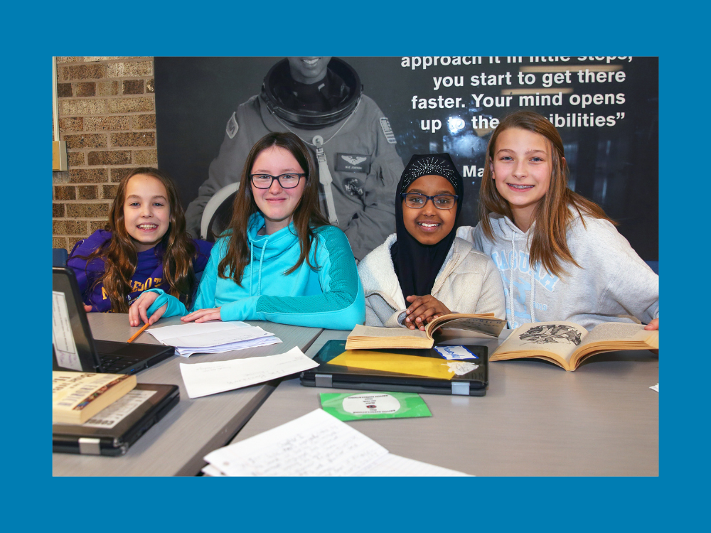 Four middle school students work on school work.