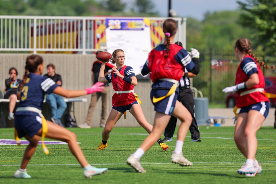 girls flag football player throwing a ball